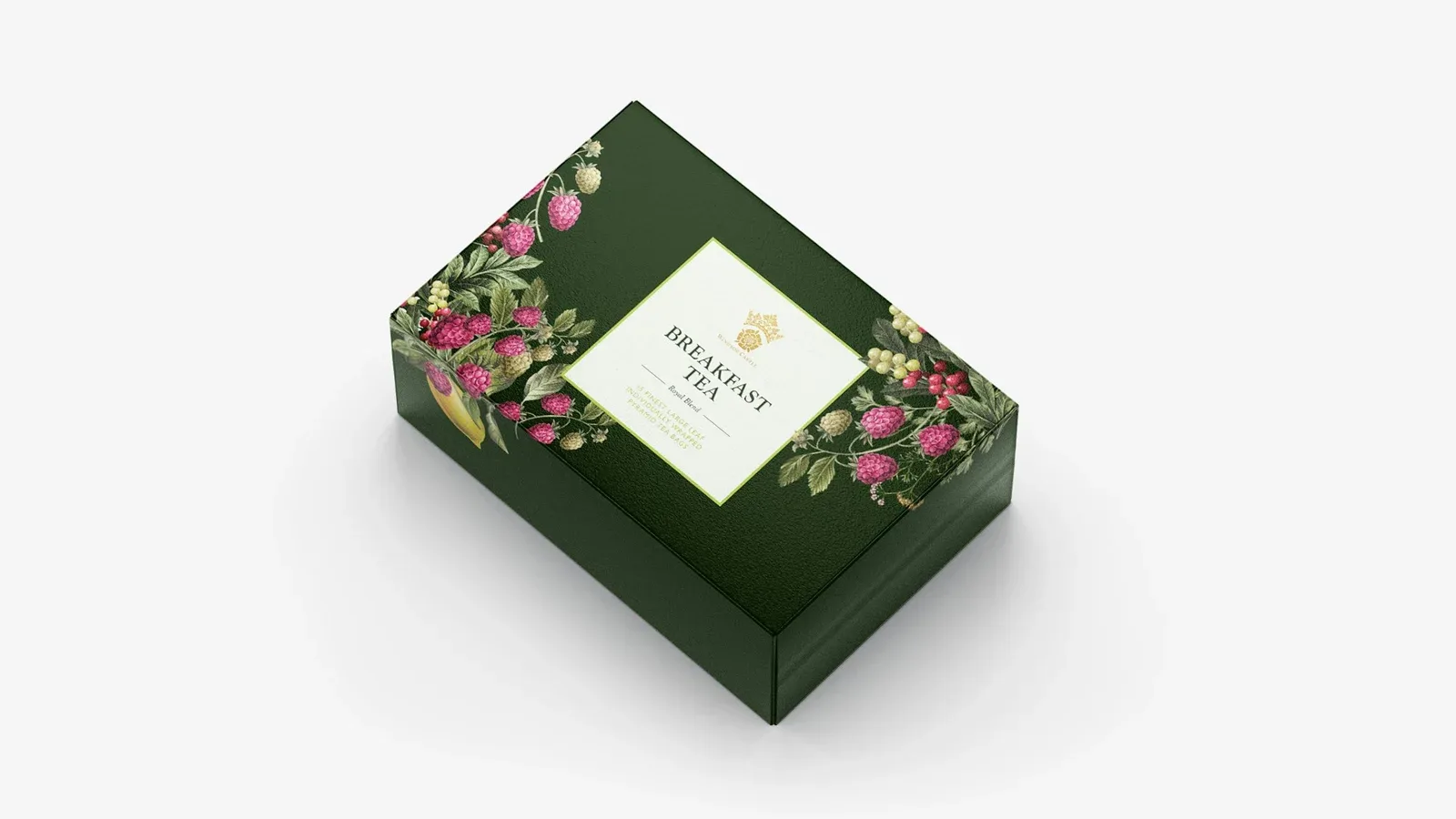 深绿色方形礼盒顶部有花卉图案和浅色标签。